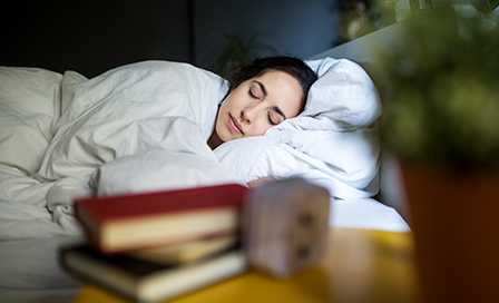 Young woman sleeping peacefully on her bed at home