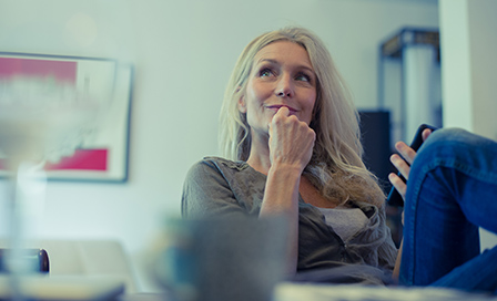 Mature woman using smartphone at home