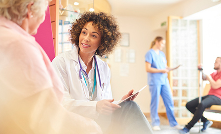 Female doctor talking to an elderly female patient. 