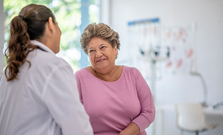 Female Hispanic doctor at an appointment with an older Hispanic woman.