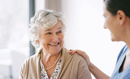 Elderly female patient talking to female doctor