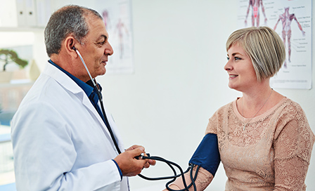 Shot of a male doctor checking his patient's blood pressure