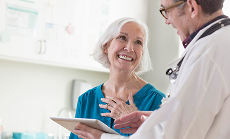 Doctor giving good exam results to female patient