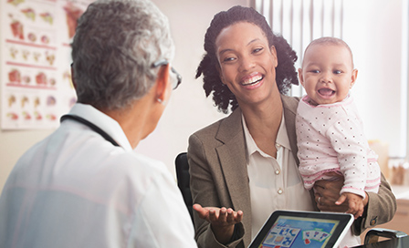 Businesswoman mother and baby visiting doctor