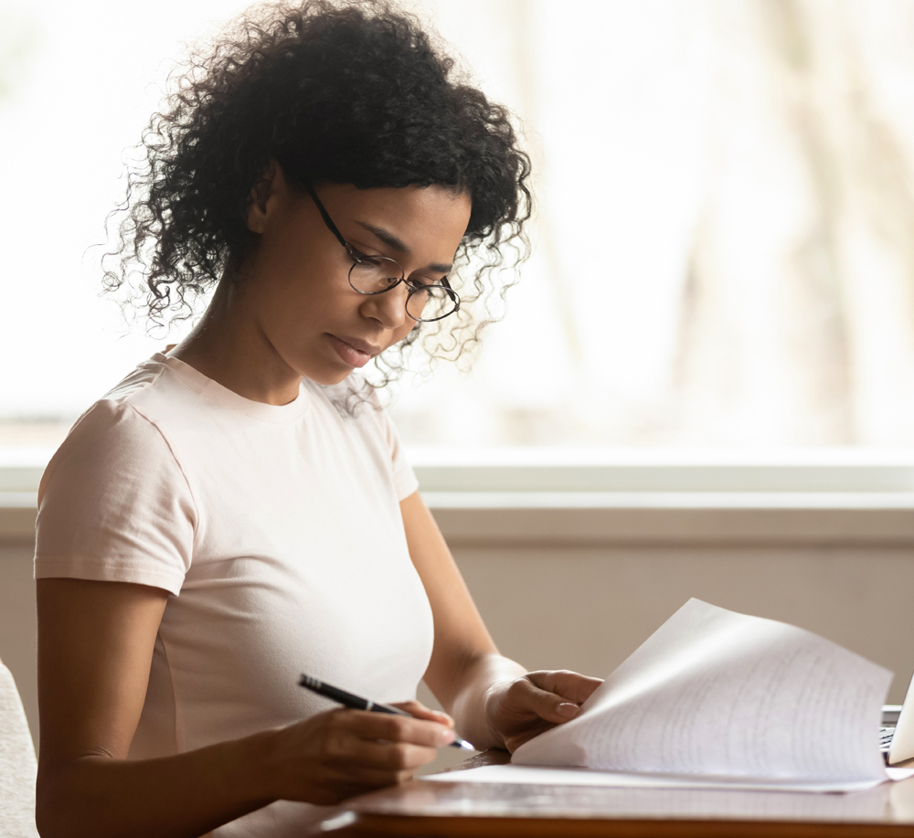 Women sitting at desk reviewing documents. 